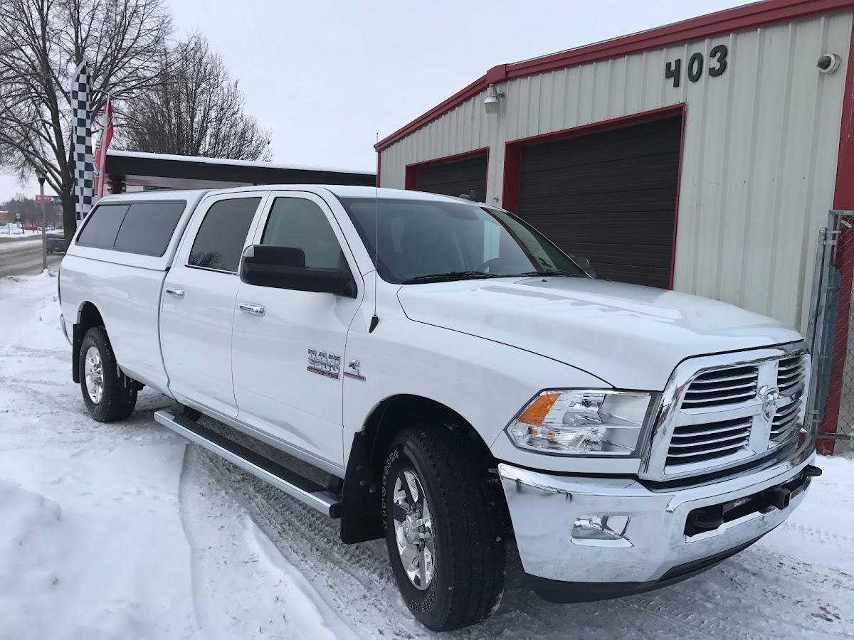 A detailed truck outside the red Arredondo Auto Details shop at 403